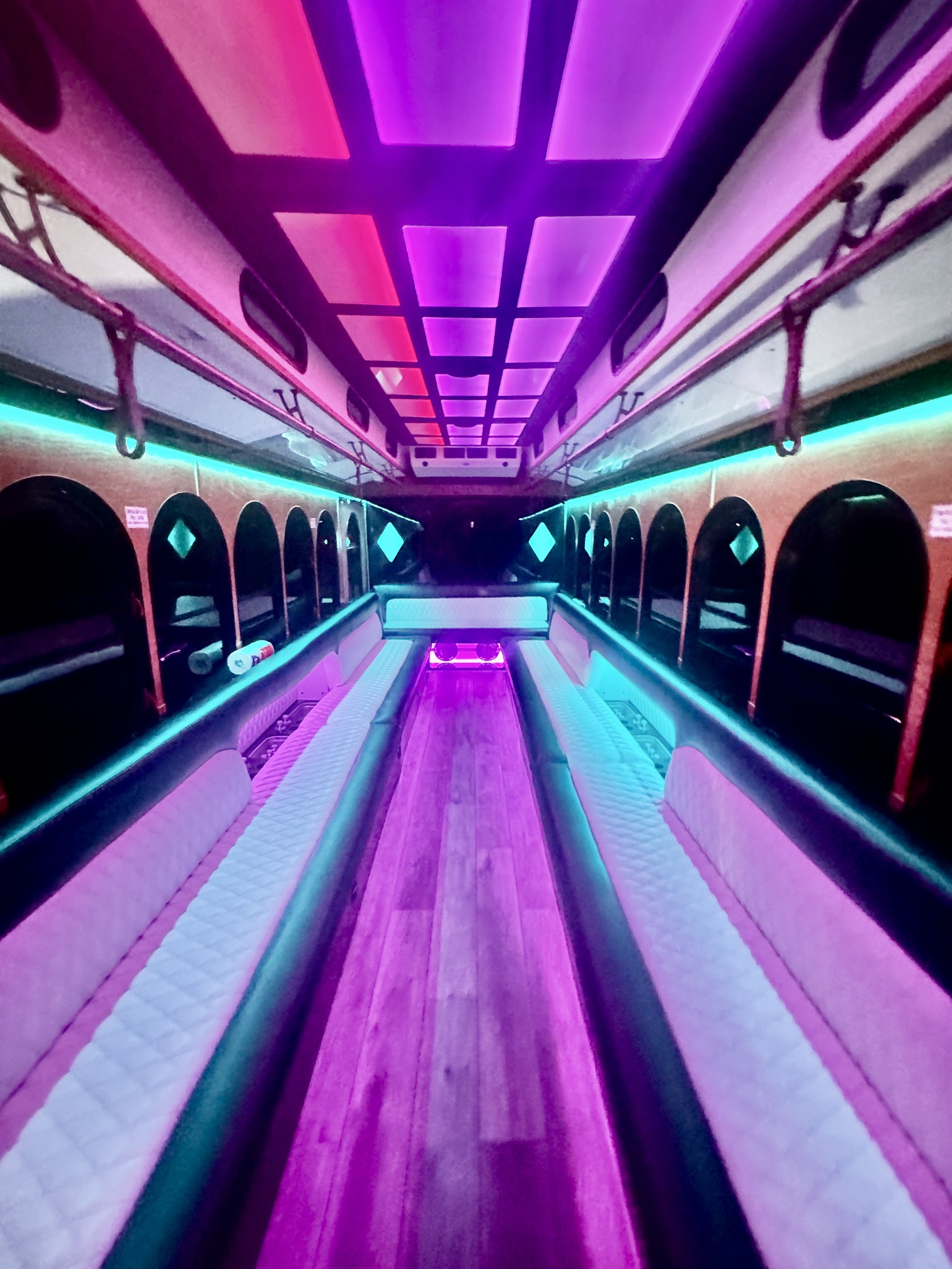 Trolley Limo interior with pink and teal LED lighting and arched windows